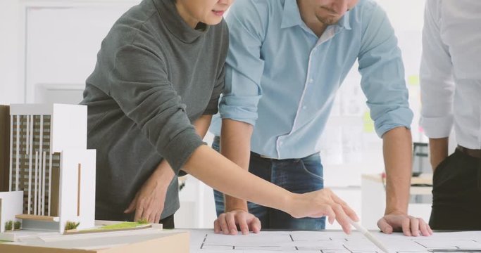 Dolly shot of Confident team of creative architects working together in a architect studio.