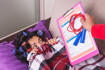 A woman in curlers does not want to do home workouts