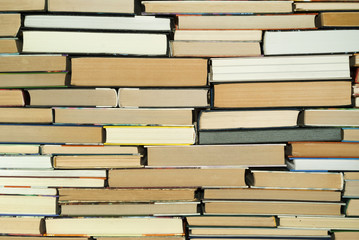 Fototapeta premium background - a wall composed of books of different sizes