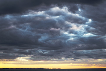 wonderful storm with gray cumulus clouds sky above the sea before bad weather