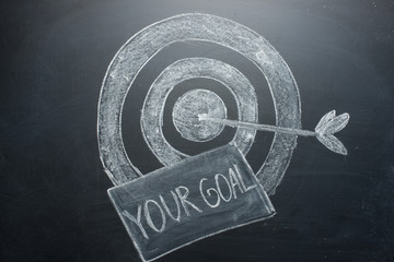 your goal is an inscription with a target on the board. The concept of winning in business and achieving the goal
