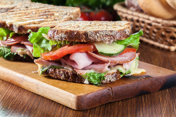 Sandwiches with ham, cheese, tomatoes, lettuce and cucumber