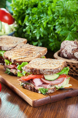 Sandwiches with ham, cheese, tomatoes, lettuce and cucumber