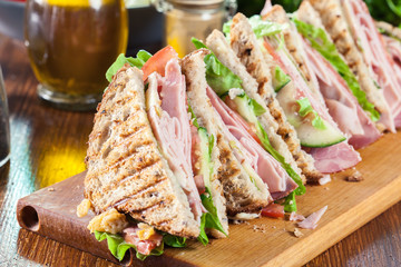 Sandwiches with ham, cheese, tomatoes, lettuce and cucumber