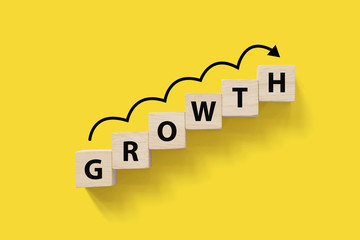 Business success growing growth increase up concept. Wooded cube block on white background with...