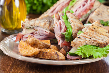 Sandwiches with ham, cheese, tomatoes, lettuce and cucumber