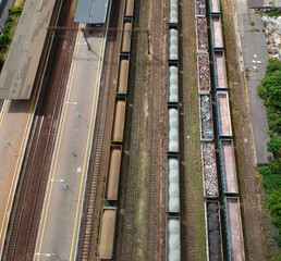 Cargo wagons on train station in city, aerial view