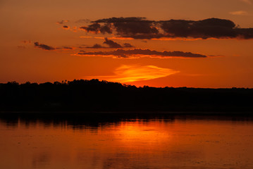Fototapeta na wymiar A beautiful summer landscape of the orange sunset over the river, Ukraine. Concept - the beauty of the planet Earth.