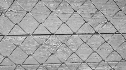 Beautiful vintage wooden wall background looks through fences. black-and-white