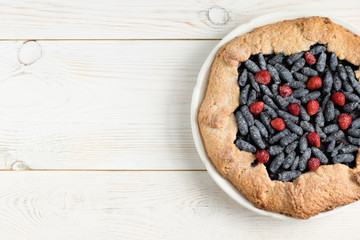 biscuit with berries on a white wooden background