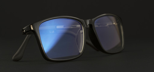 Anti blue light computer glasses on the black background.