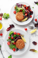 Home made Fish Cake salmon, spinach and potato. served on plate with vegetables