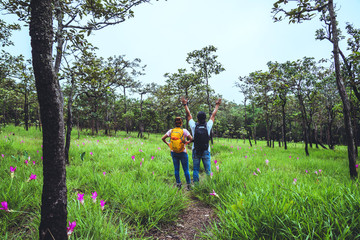 Lover woman and men Asian travel nature. Travel relax. Photography Cucumber sessilis flower field.