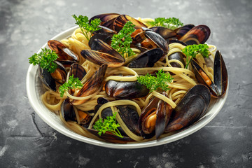 White wine and garlic steamed mussels with pasta served with parsley