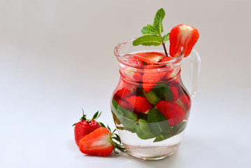 Summer fresh fruit flavored infused water of strawberry and mint. Space for test or design.