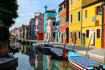 Fototapeta na wymiar Canal with colorful buildings and houses in Burano island, Venice, Italy - Famous Architecture and landmarks