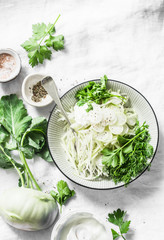 Kohlrabi and daikon slaw salad on a light background, top view. Vegetarian diet food concept