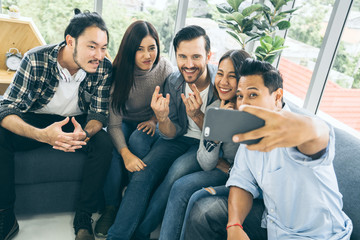 GROUP OF MULTI NATION FRIENDS TAKE SELFIE TOGETHER WITH HAPPINESS AND JOYFUL