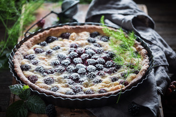 Homemade tart made of blackberries and caster sugar