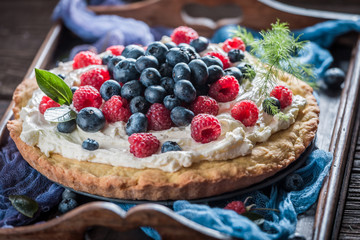 Sweet and tasty pie with fresh blueberries and raspberries