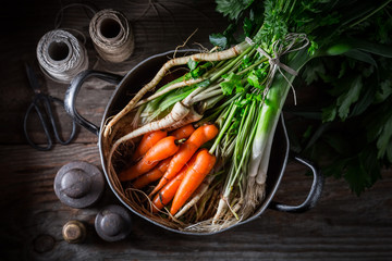 Ingredients for homemade vegan soup with parsley, carrots and leek