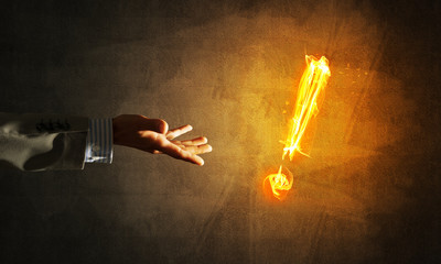 Concept of attention or punctuation with burning exclamation mark on dark background