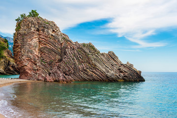 Fototapeta premium Adriatic sea coastline near Budva city in Montenegro, gorgeous seascape with big rock in the beach