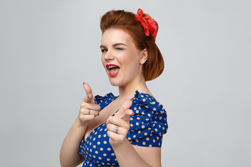 Portrait of gorgeous beautiful young ginger woman winking eye and smiling at camera, opening mouth...