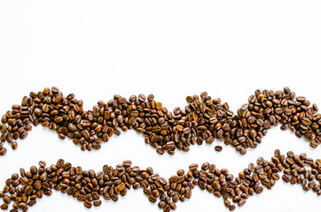 Roasted coffee beans pile on white background a view from the top.
