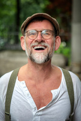 Fototapeta premium portrait of laughing bearded man in his 50s