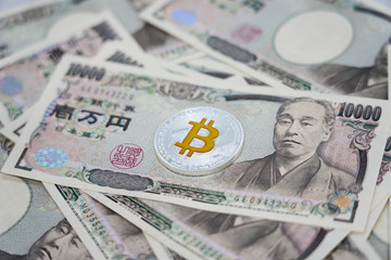 Close up of japanese bank note with silver bit coin.