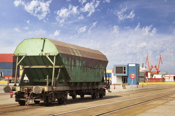 Lonely goods van on a railroad at container terminal in a marine port waiting for cargo