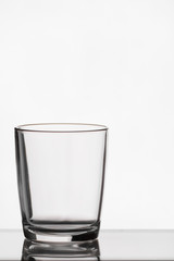 Empty crystal glass with reflection on white isolated background