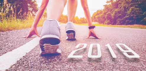 2019 symbolises the start into the new year.Start of people  running on street,with sunset...
