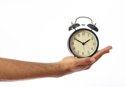 Alarm clock on a hand palm isolated on white background, clipping path