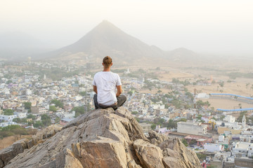The photographer is sitting on a mountain top looking down on a small village in Rajasthan, India.
