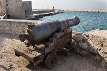 Artillery cannon gun in front of Carlo V Castle in port Monopoli, Apulia, Bari province, Italy