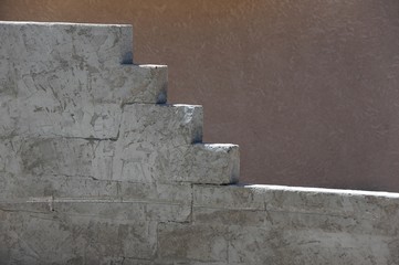 Cinder block wall detail.  Stucco wall in background. 