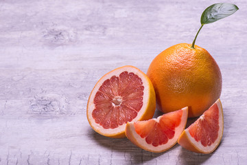 Grapefruit slices, juicy ripe isolated on a gray background.