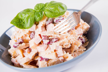 Pasta salad with cheese, ham, kidney beans and mayonnaise