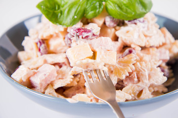 Pasta salad with cheese, ham, kidney beans and mayonnaise 
