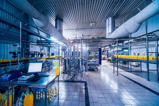 Beverage factory interior. Conveyor with bottles for juice or water. Equipments