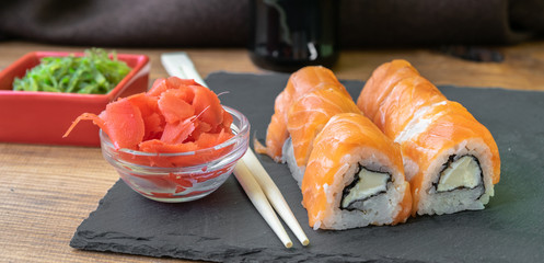 sushi is served on a black stone plate