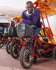 Nice driver of pedicab offering touristic tour