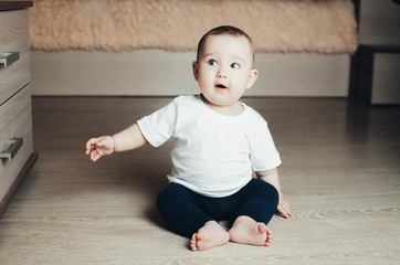 little baby girl sitting on the floor