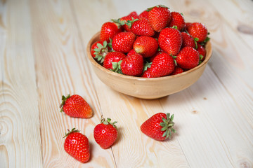 Strawberries in wooden bowl. Fresh nice strawberries on wooden table. Juice strawberry