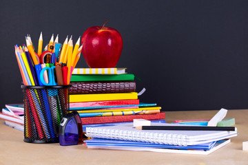 School supplies on blackboard background with copy space.