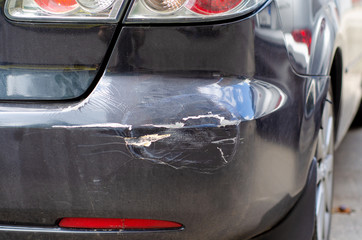 Black car dent rear bumper in the street  broken - obrazy, fototapety, plakaty