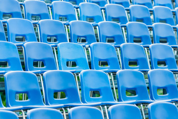 Naklejka premium Empty blue plastic seats in the audience.
