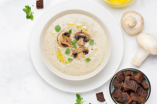 Mushroom cream soup with cream, croutons of dark bread, olive oil, tasty healthy food